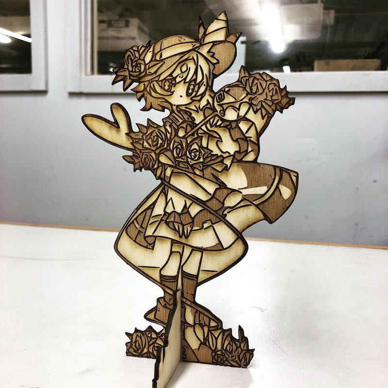 A wood laser-cut figure of an image as a standing decoration.